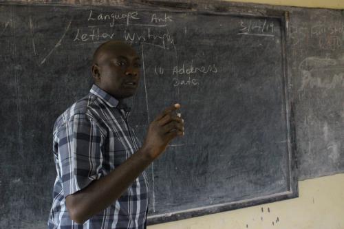 Abubakarr teaching in Class.