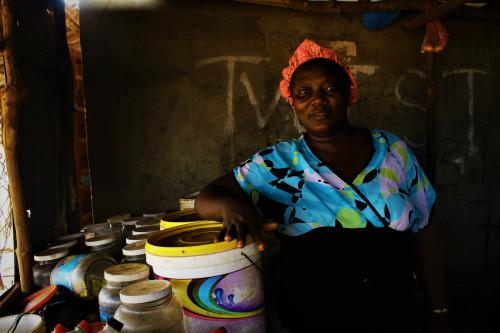 Isatu Turay Poses close to her wares that she sells.