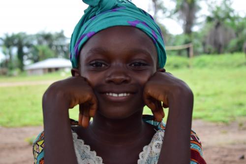 Aminata poses happily after a reading session.