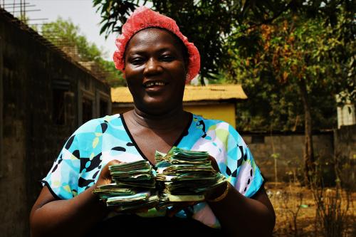 Isatu Turay displaying her cash received from the Share out.