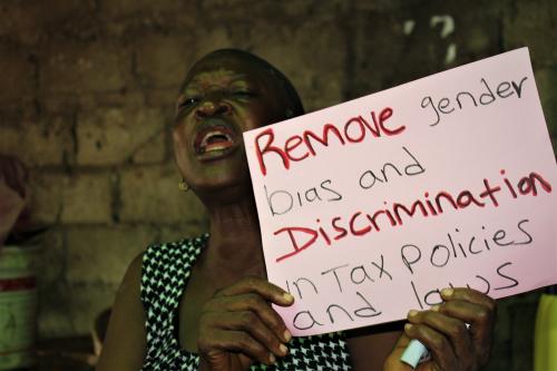 Another Market Woman displaying her placard.