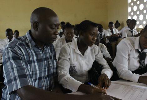 Abubakarr Sesay, Teacher Monitoring a Pupil during Class Work