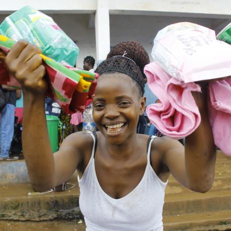 Christiana display her dignity Kits that is supplied by ActionAid