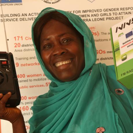 Mariama Feika, Community Animator-Come Sierra Leone displays her Radio